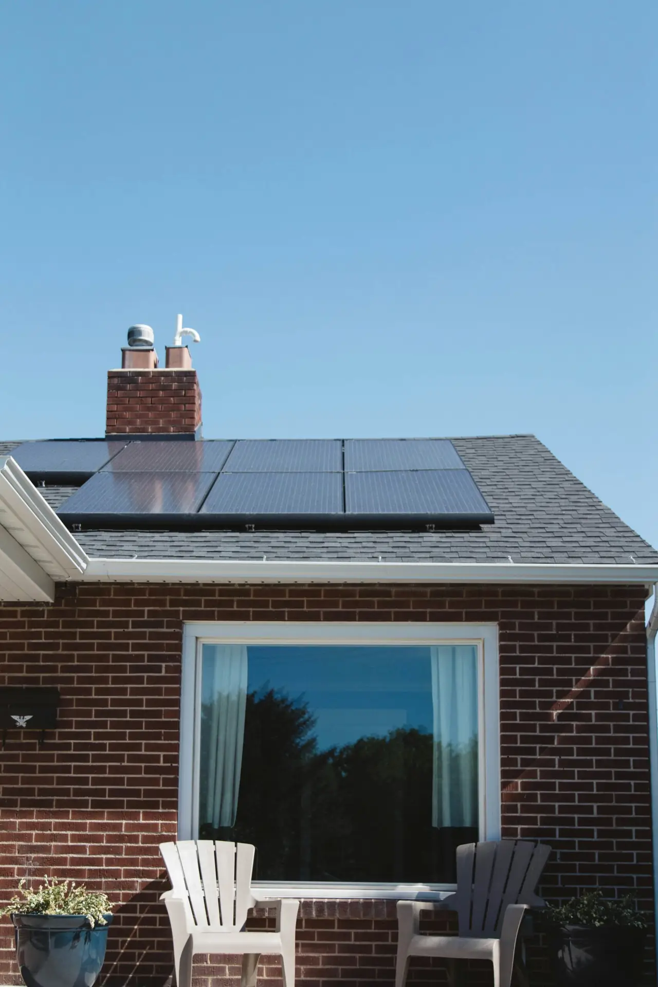 Residential rooftop with installed solar panels, highlighting sustainable energy solutions for homes.